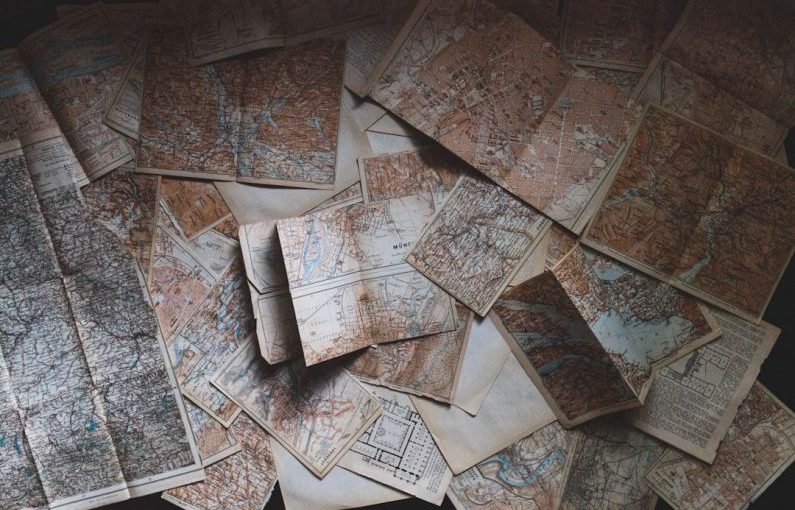 Solo Budget Travel - maps lying on the floor