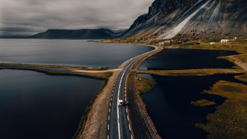 Iceland Landscape - gray concrete road near mountain during daytime